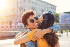 Women smiling outside and hugging each other. Your identity should be something you hide. Getting support matters. Try LGBTQIA+ counseling in North Carolina or Virginia with a LBGTQIA+ friendly therapist today!
